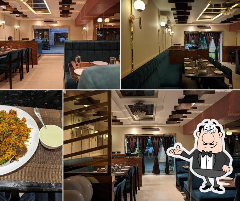 Take a seat at one of the tables at Amrut - Fine Dining Restaurant