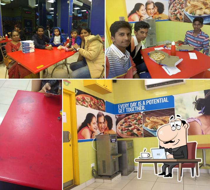 Take a seat at one of the tables at Domino's Pizza KLE University. Belagavi