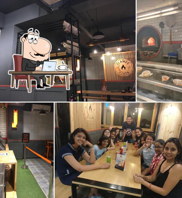 Take a seat at one of the tables at Flames Pizza