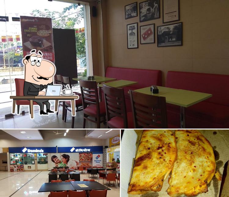 Check out the picture showing interior and pizza at Domino's Pizza RT Nagar, Bangalore
