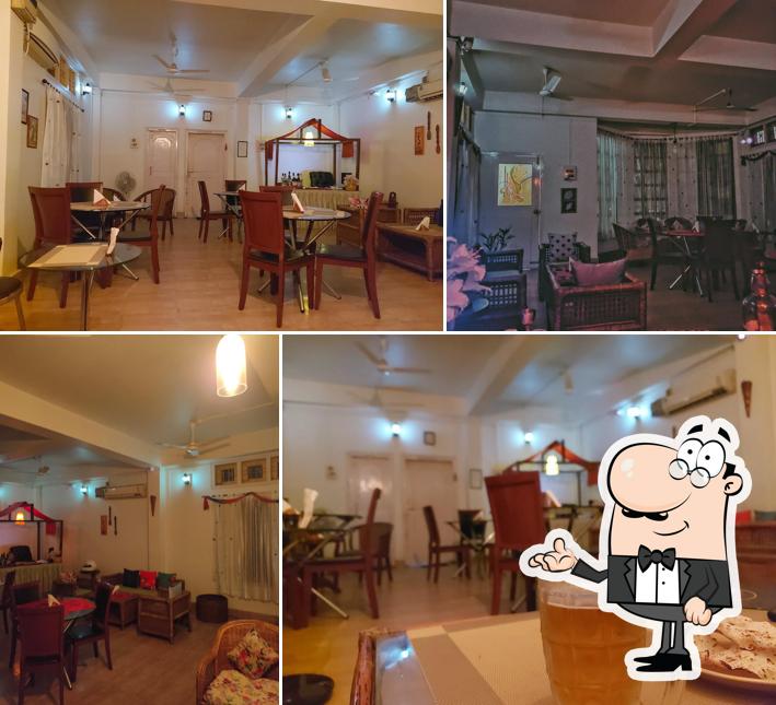 Take a seat at one of the tables at Prashanti Bar cum Restaurant