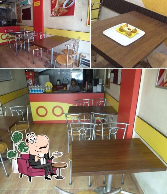 Take a seat at one of the tables at Samosa Junction