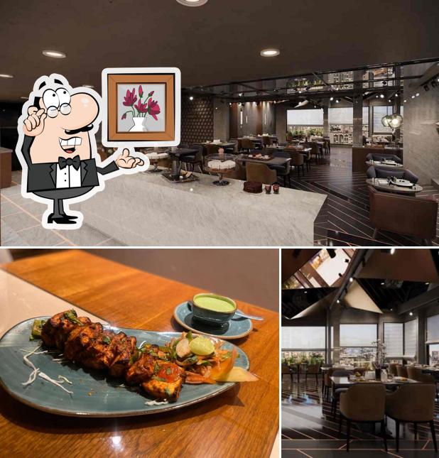 Take a seat at one of the tables at Spiceville Restaurant - By Hotel Nalanda