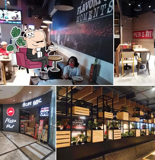 Take a seat at one of the tables at Pizza Hut Phoenix Market City, Chennai