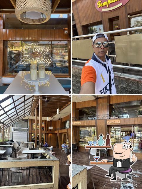 Take a seat at one of the tables at The Temptation Vasco - 24x7 Complete Food Shop