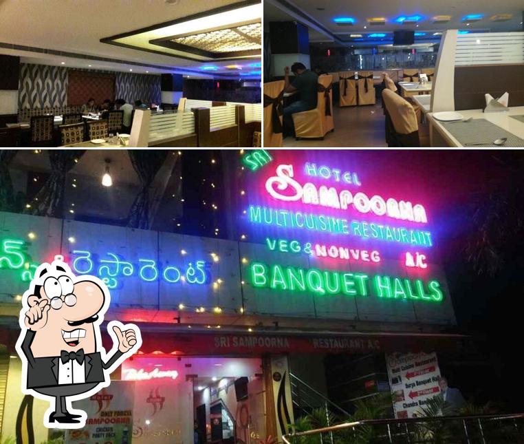 Take a seat at one of the tables at Sri Sampoorna Hotel