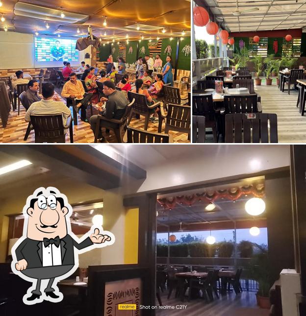 Take a seat at one of the tables at Hotel Maratha Family Restaurant & Bar