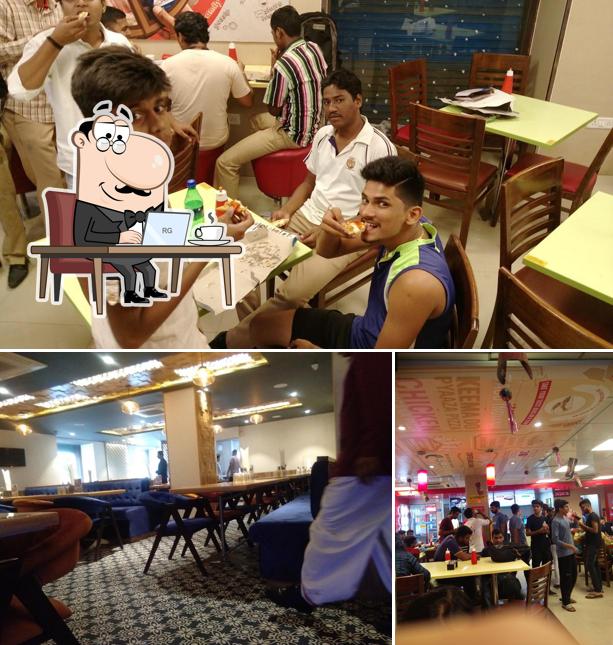 Take a seat at one of the tables at Domino's Pizza Mama Parmanand Marg, Goregaon
