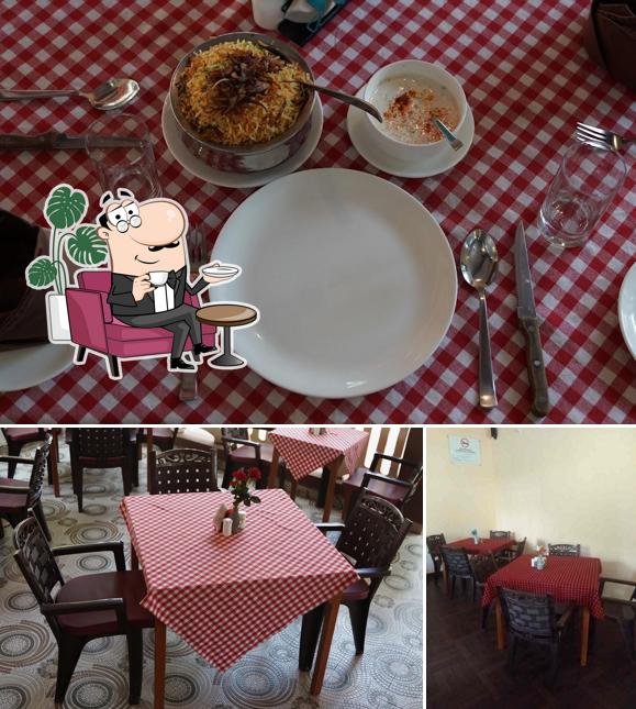 Take a seat at one of the tables at The Meeting Bar And Restaurant by Ellina