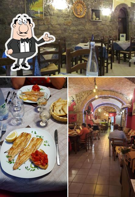 Questa è la foto che mostra la interni e tavolo da pranzo di Pizzeria Trattoria La Tavernetta