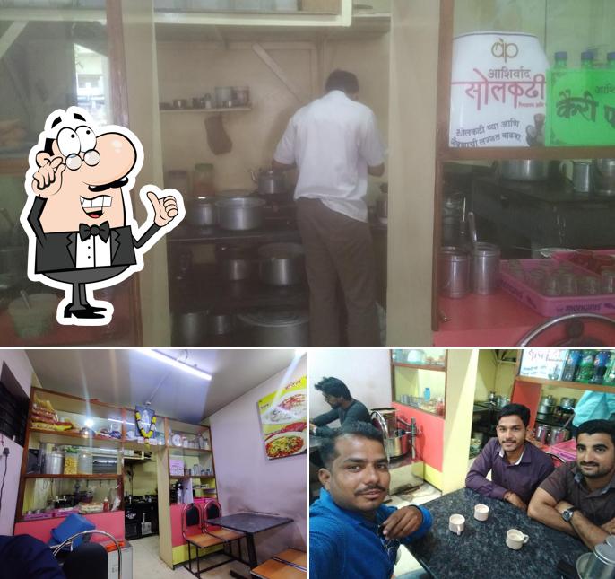 Take a seat at one of the tables at Hotel Jay Shreeram Restaurant South Indian, Snacks, Sandwich