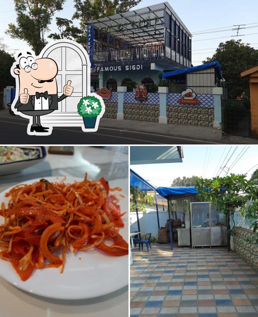 Take a look at the photo displaying exterior and food at Famous sigdi