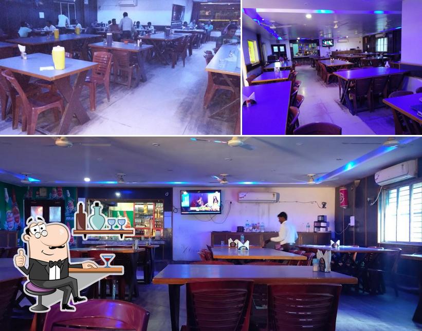 Take a seat at one of the tables at Relax Bar And Restaurant