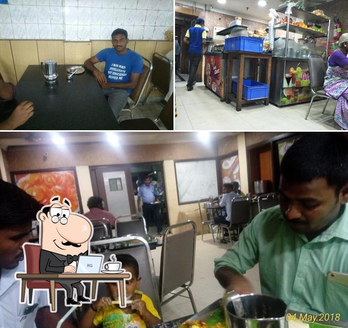 Take a seat at one of the tables at Adyar Ananda Bhavan - A2B