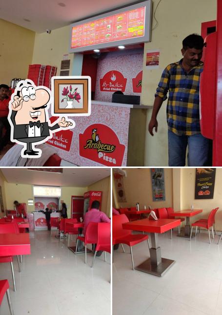 Take a seat at one of the tables at Al- Baike ( Fried Chicken)