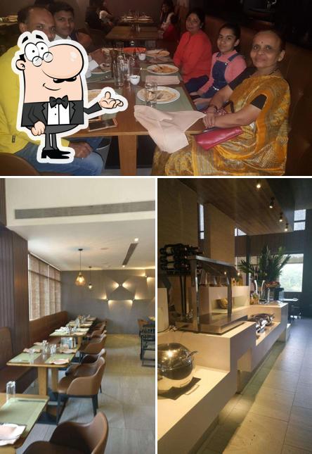 Take a seat at one of the tables at Little Italy Restaurant, Lullanagar Pune