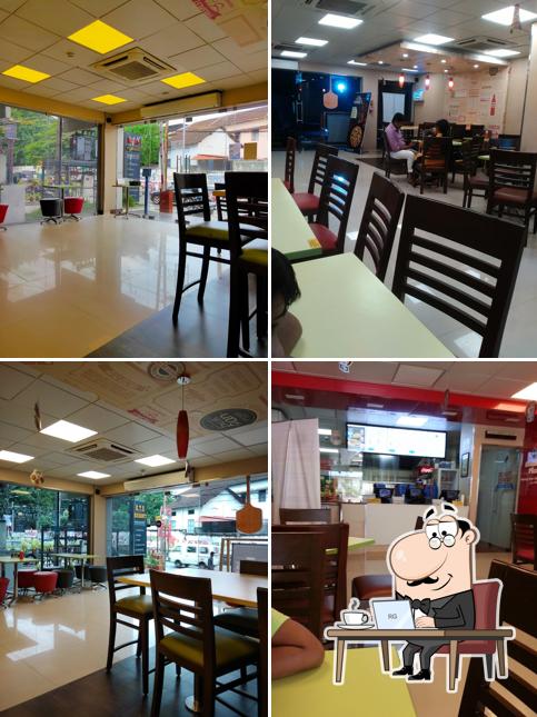 Take a seat at one of the tables at Domino's Pizza Vinayaka colony, Palakkad
