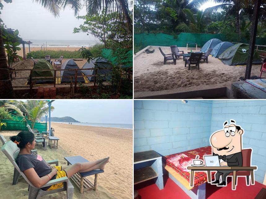 Take a seat at one of the tables at Prakruthi cafe and Rooms (PRAKRUTHI GOKARNA)
