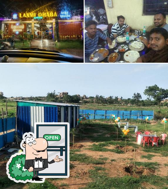 Take a look at the image showing exterior and dining table at Lakshmi Dhaba - ಲಕ್ಷ್ಮಿ ಧಾಬಾ