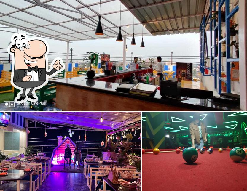 Take a seat at one of the tables at EMBASSY CLUB & SKY LOUNGE