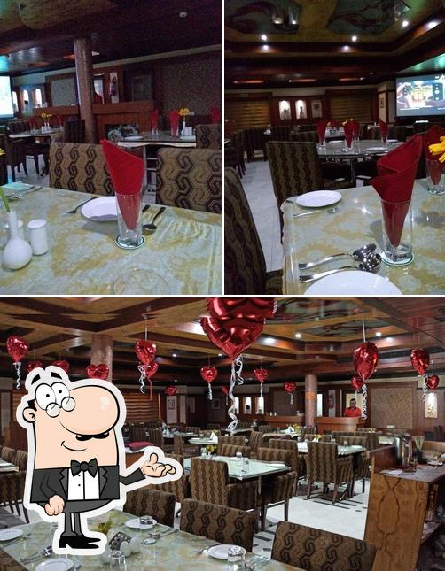 Take a seat at one of the tables at Grand Darbar Restaurant