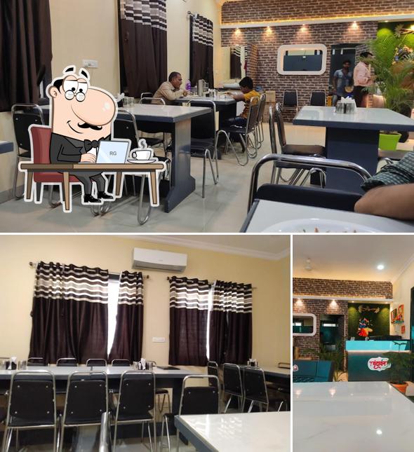 Take a seat at one of the tables at Vrundavan Veg Restaurant