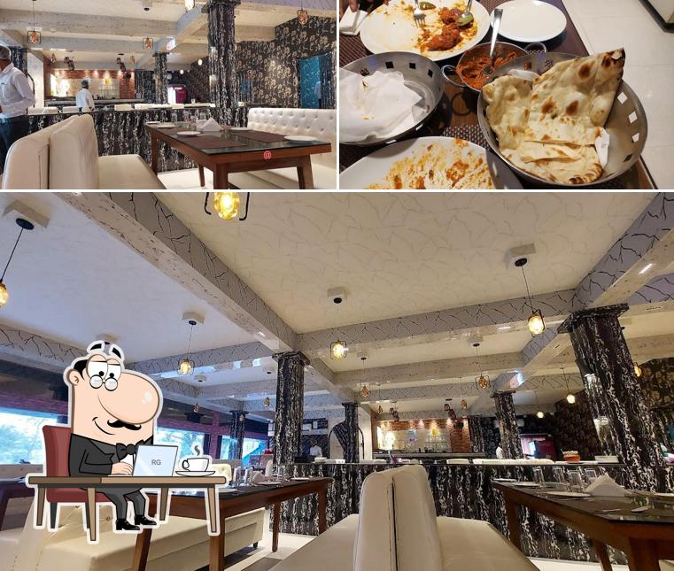 Take a seat at one of the tables at Basirhat Sona Hotel