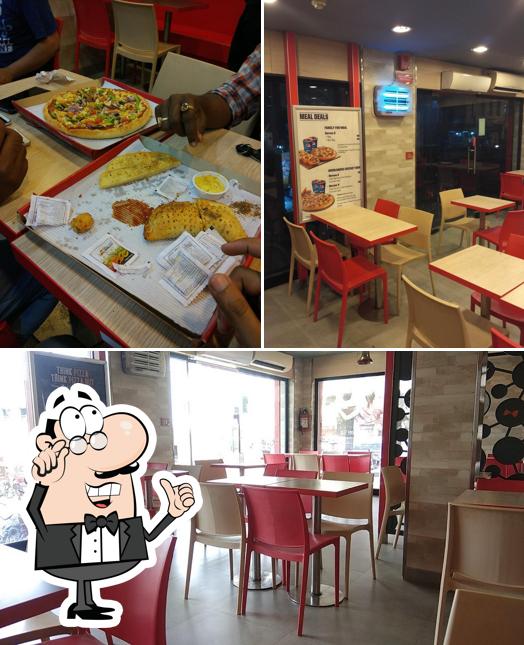 Take a seat at one of the tables at Pizza Hut Mithanpur Chowk, Muzaffarpur