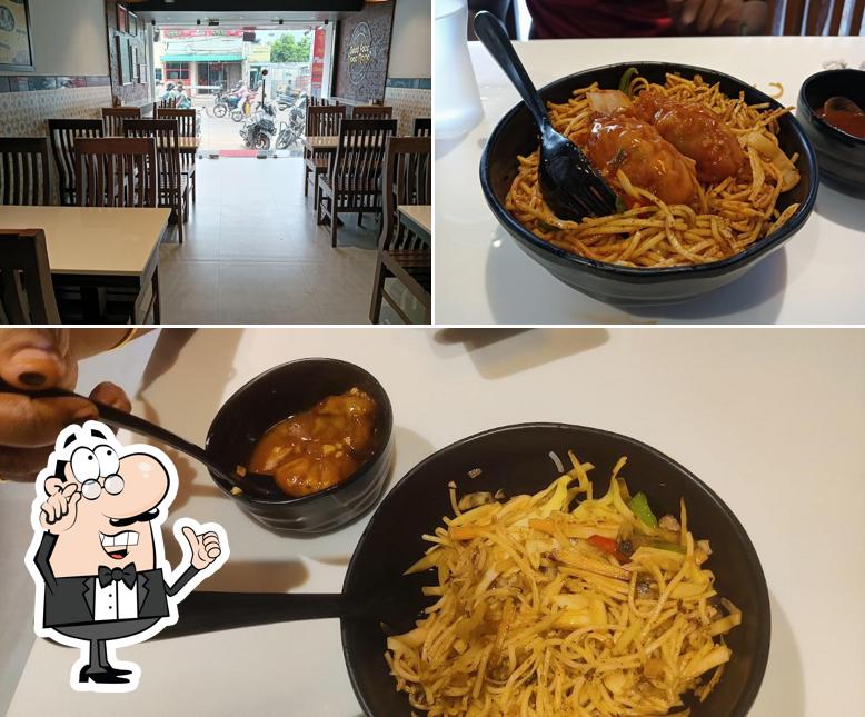 Take a look at the image displaying interior and food at JOJO MOMOS - Gugai