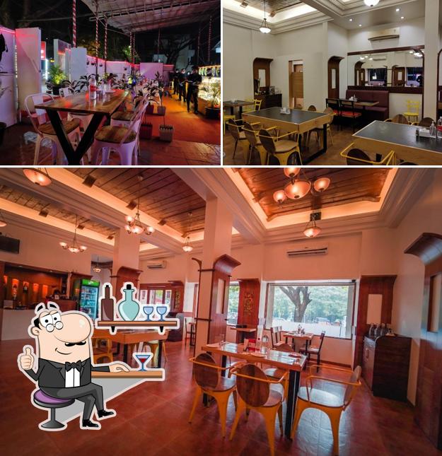 Take a seat at one of the tables at HER HIGHNESS RESTAURANT & COCKTAIL BAR