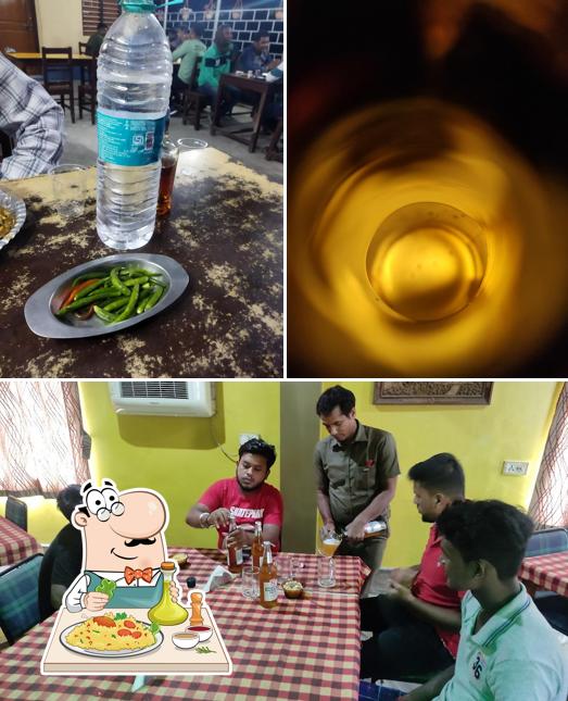 Among various things one can find food and dining table at Kalyan Hotel and restaurant