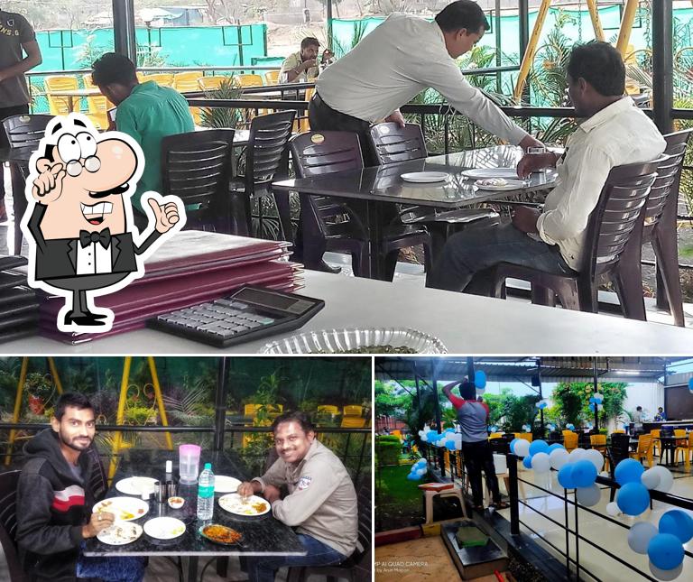 Take a seat at one of the tables at Aaswad Veg Restaurant