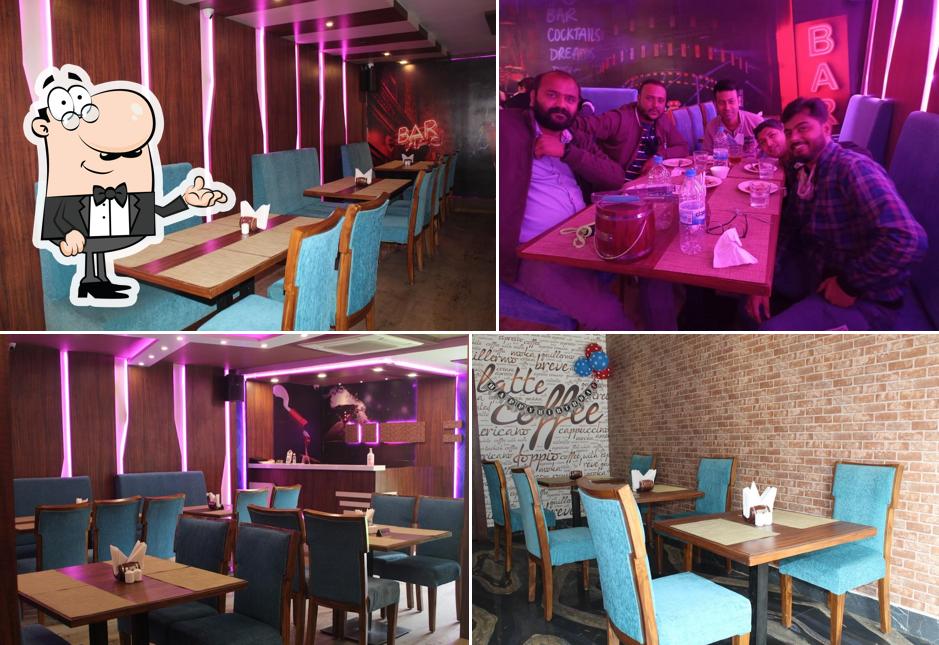 Take a seat at one of the tables at Baithak Bar & Restaurant
