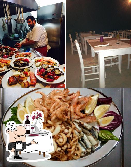 La foto di tavolo da pranzo e frutti di mare da Onda Marina - Trattoria e Pizza Napoletana Ugento