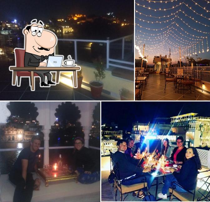 Take a seat at one of the tables at Daagla Restaurant (Lake Side Rooftop Restaurant Udaipur)