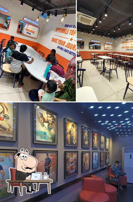 Take a seat at one of the tables at GOPIZZA Asian Satyam Mall