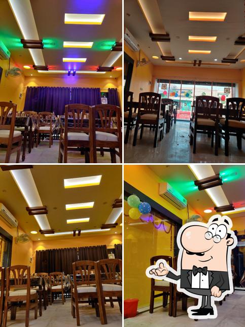 Take a seat at one of the tables at Mahamaya Restaurant & sweet plaza