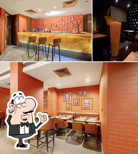 Take a seat at one of the tables at One Too Many - Regenza By Tunga