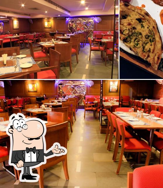 Take a look at the image depicting interior and pizza at Vrindavan Restaurant