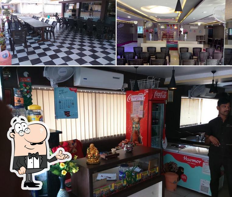 Take a seat at one of the tables at Hotel NILKANTH Kathiyawadi & Panjabi