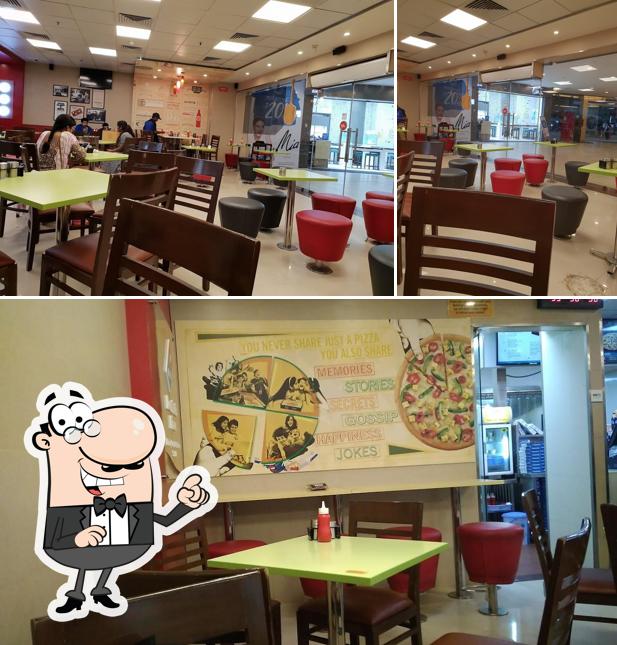 Take a seat at one of the tables at Domino's Pizza