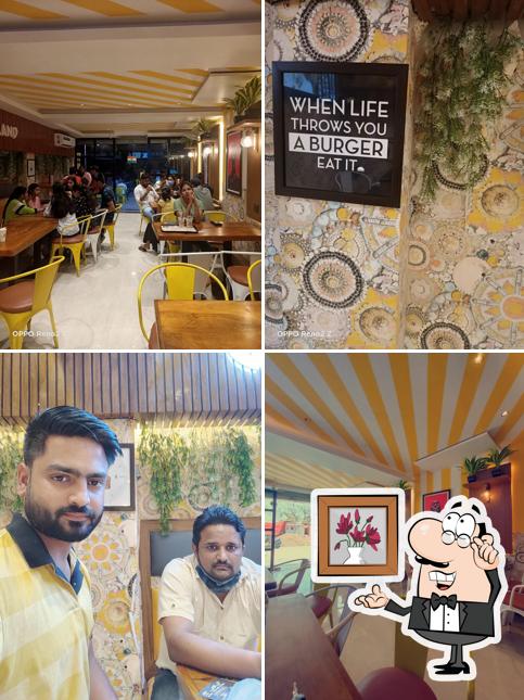 Take a seat at one of the tables at Burgerland Chhatarpur