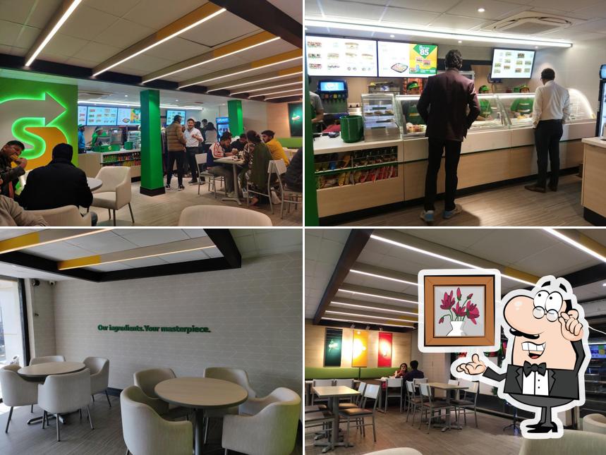 Take a seat at one of the tables at Subway