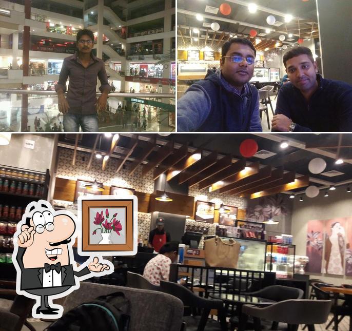 Take a seat at one of the tables at Café Coffee Day