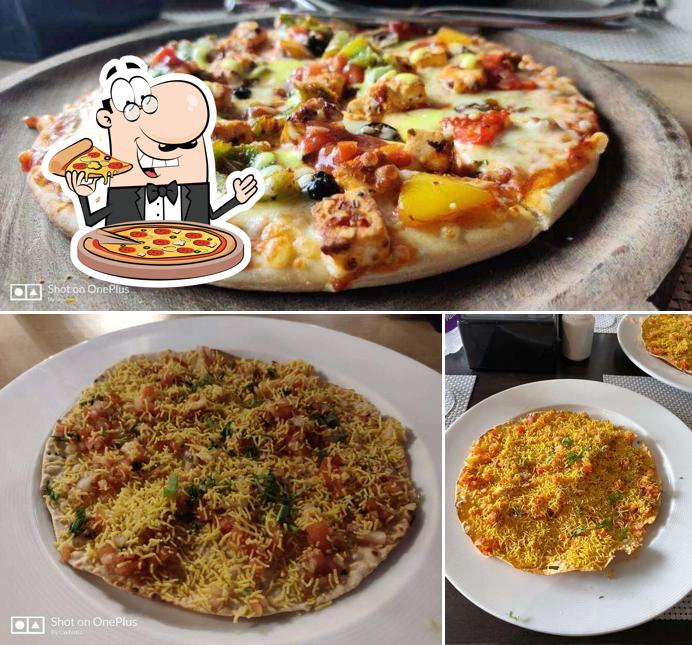 Try out pizza at Hotel Blu Grass Banquet Fine Dine Restaurant