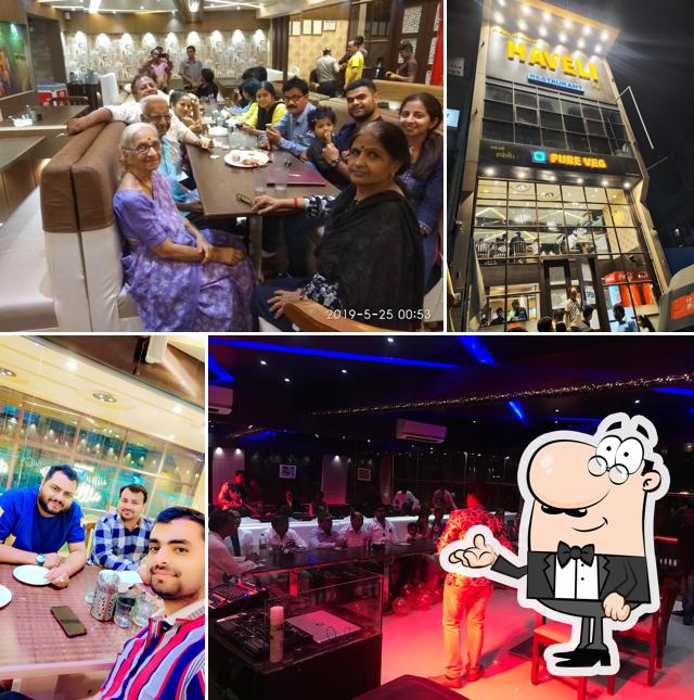 Take a seat at one of the tables at Aao Kabhi Haveli Pe Restaurant