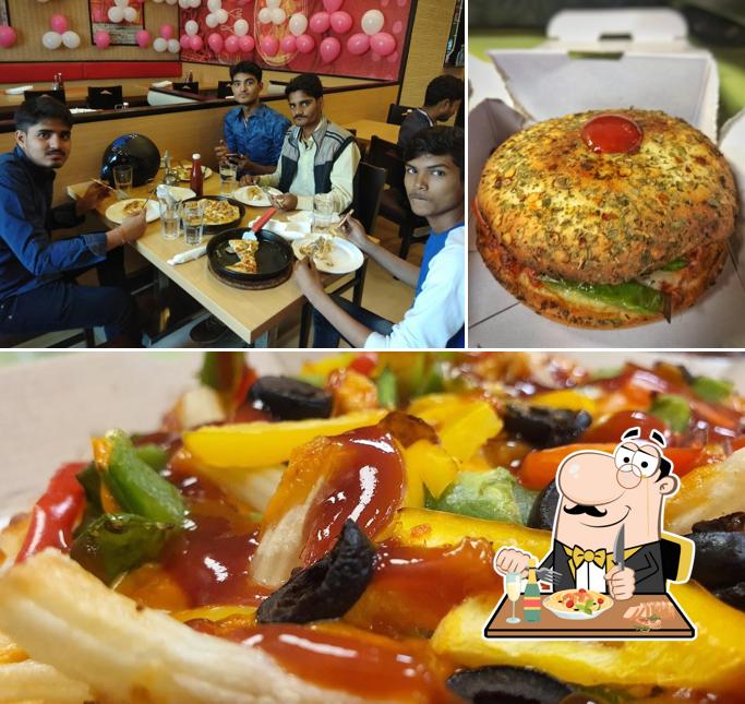 Check out the picture showing food and dining table at Domino's Pizza Boobna Plaza, Hajipur