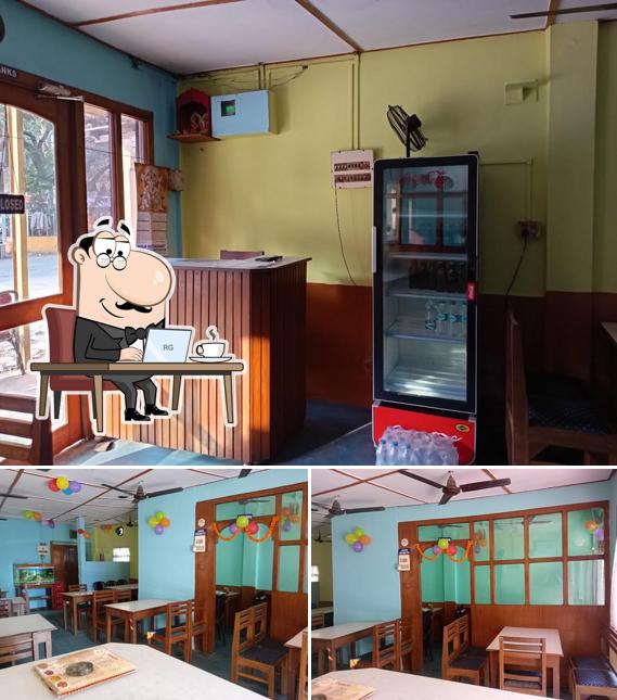 Take a seat at one of the tables at Pooja Restaurant