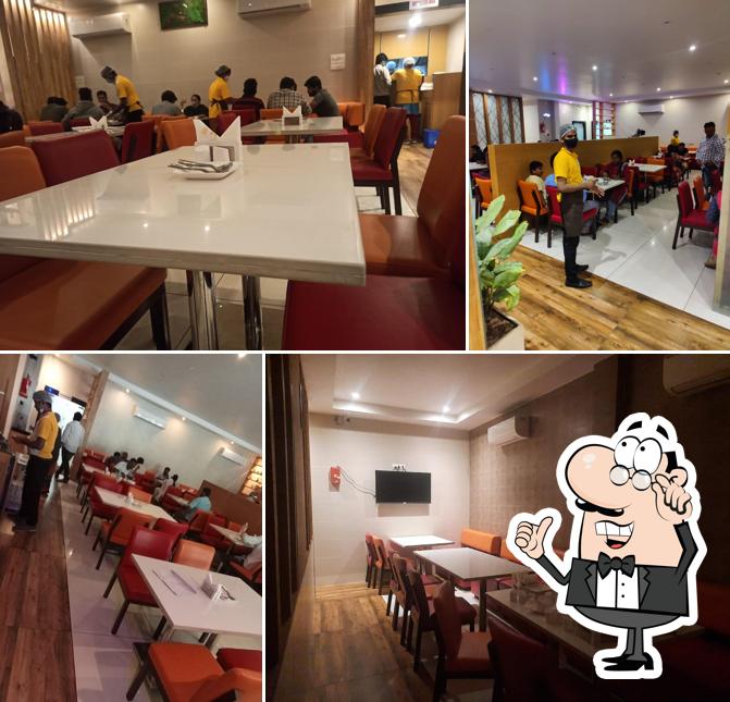 Take a seat at one of the tables at Biryanis and More - Khammam