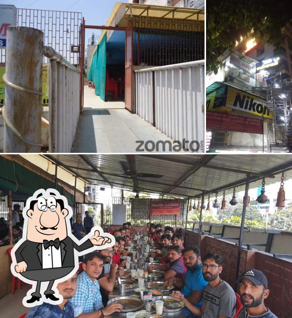 Take a seat at one of the tables at Shivshakti Kathiyawadi - Paldi